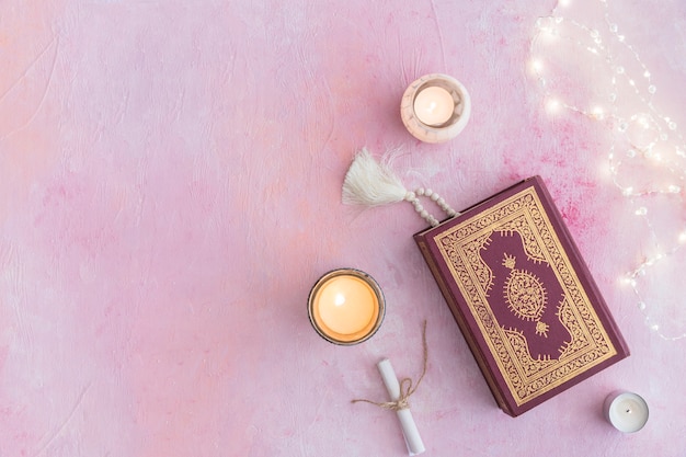 Koran with beads and candles Photo Free Download