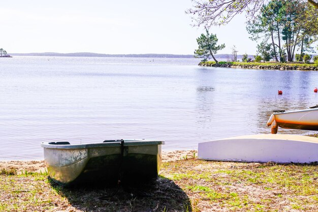 premium-photo-lacanau-medoc-water-beach-lake-coast-with-boats-on-sand