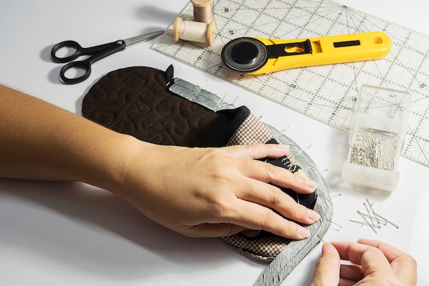 Lady is making handmade cloth soft shoe Free Photo