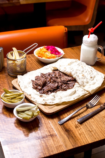 Free Photo | Lamb doner kebab in flatbread served with pickles and ...