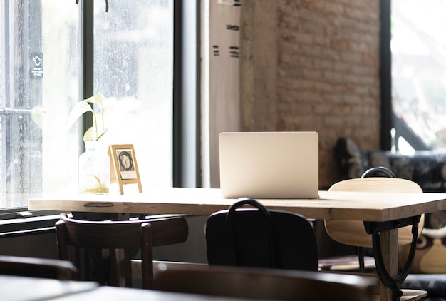 Laptop computer with co working space cafe Premium Photo