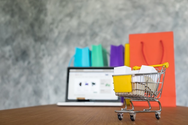 Laptop and shopping bags, online shopping concept Free Photo