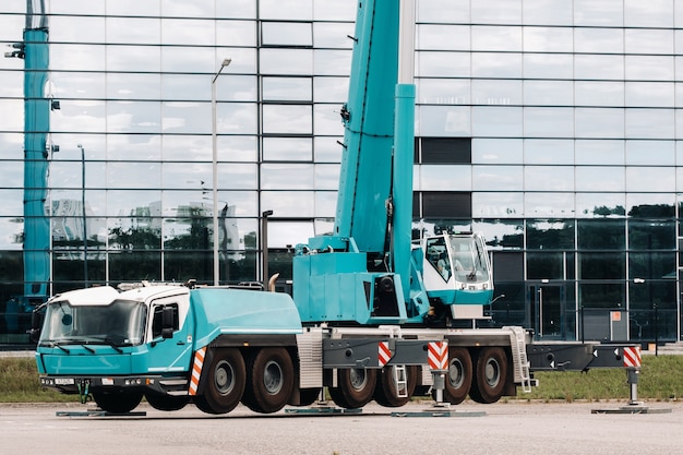 Premium Photo | A large blue truck crane stands ready to operate on ...