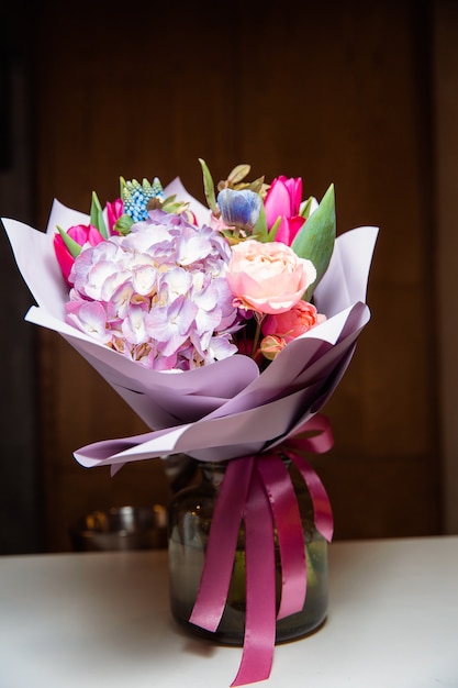 Premium Photo A Large Bouquet Of Colorful Flowers Of Various Kinds Stands In A Transparent Glass Vase