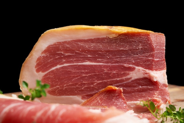 Premium Photo | Large piece of prosciutto an italian ham made with a ...