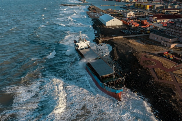 Premium Photo | A Large Seagoing Vessel Dry Cargo Ship Washed Ashore ...