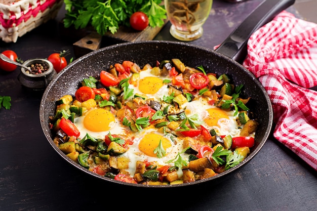 Premium Photo | Late breakfast - fried eggs with vegetables. shakshuka ...