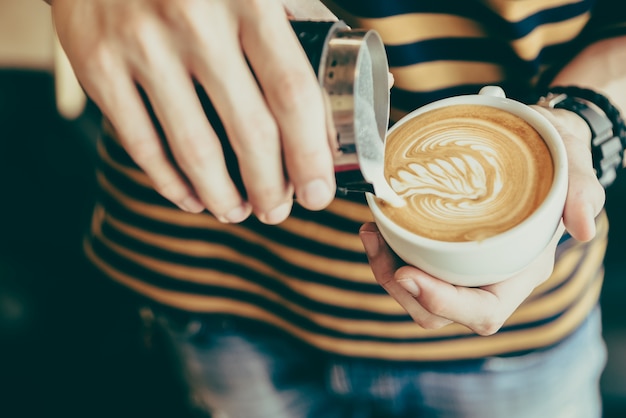 Latte art coffee cup | Free Photo