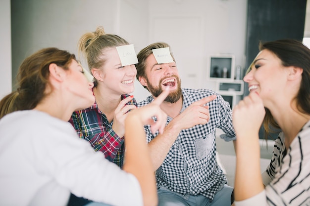 Free Photo | Laughing friends playing game with stickers