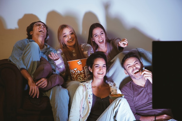Laughing friends watching a movie Free Photo