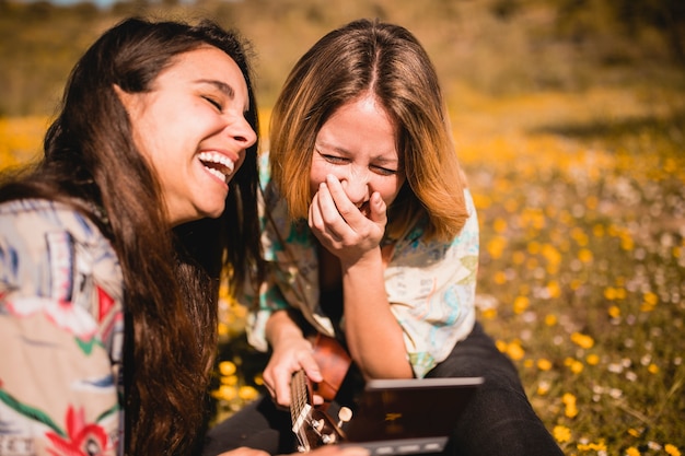 Laughing women with picture Free Photo