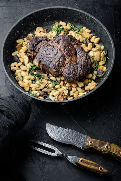 Premium Photo Legendary Grilled Rib Eye With Beans Set On Frying Cast Iron Pan With Meat 