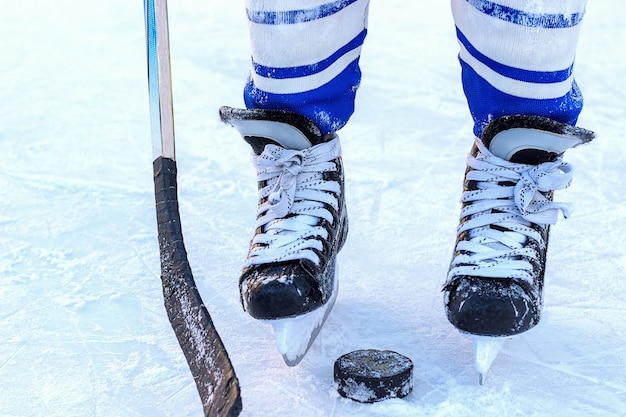 Premium Photo The Legs Of The Hockey Player Stick And Washer Close Up