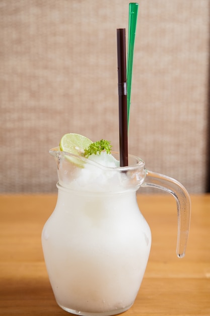 Premium Photo | Lemon juice smoothie in glass jar with starw on the ...