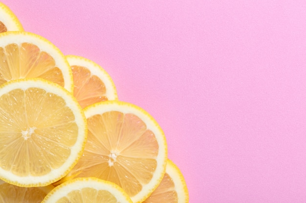 Premium Photo | Lemon slices on a pink background