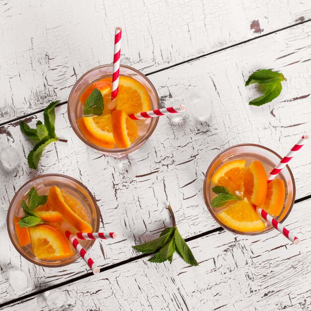 Lemonade With Orange Soda And Mint On White Wooden Table Top View Premium Photo