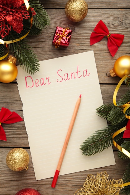 Premium Photo | Letter to santa claus with christmas decoration on grey