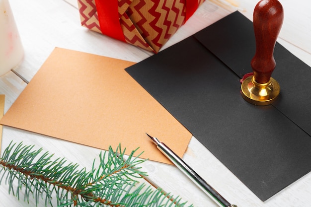 Letter to santa claus with sealing wax stamp on wooden table Premium Photo