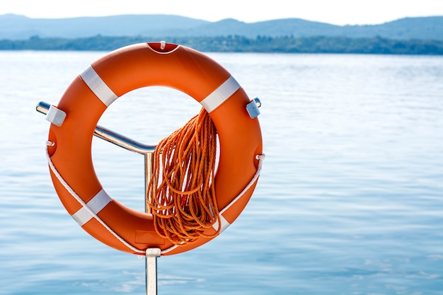 Premium Photo | Life preserver on pole at beach at the sea.