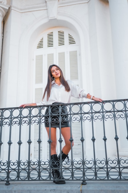 Premium Photo | Lifestyle, a young brunette in a leather skirt and a ...