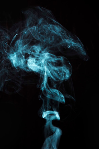 Free Photo | Light blue smoke on black background