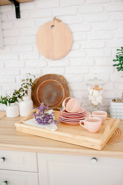 Premium Photo Light Wooden Kitchen Interior Beautiful Kitchen Interior Design Pale Pink Tableware Plates Cups