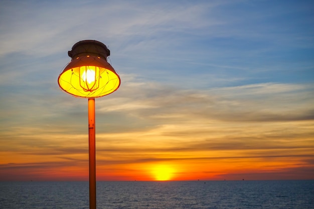 Premium Photo | Lighting of warm lamp and lighting of sunset at sea.