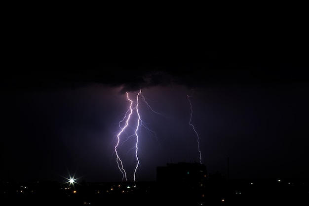 Premium Photo | Lightning storm over the city in purple light.