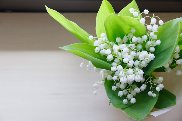 Premium Photo | Lily of the valley on wooden background