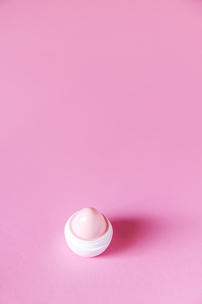 Premium Photo | Lip balm for dry lips in small white plastic container