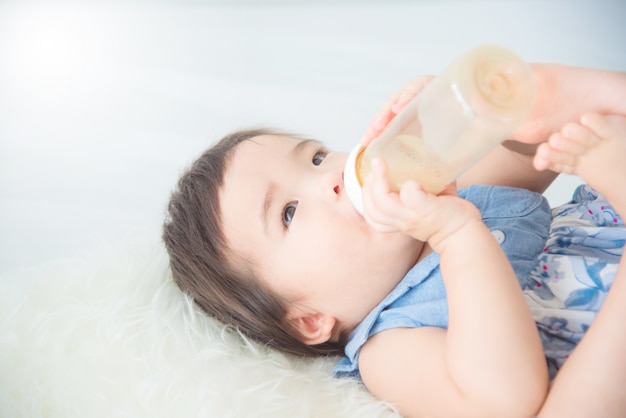 baby drinking milk from bottle