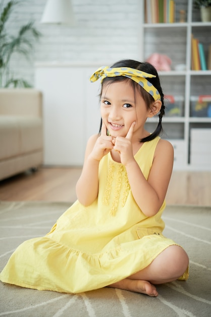 Free Photo Little Asian Girl Sitting On Floor At Home And Po
