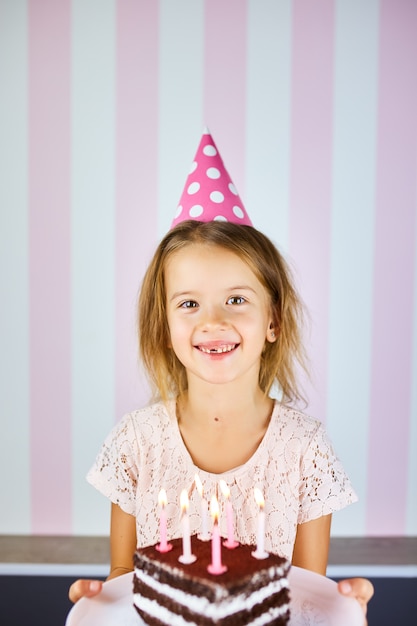 Premium Photo | Little blonde girl smiling in birthday pink cap, a ...