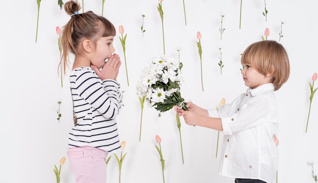 Free Photo Little Boy Giving Flowers To Girl