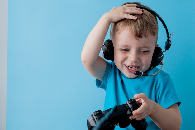 Premium Photo | Little boy holding a joystick