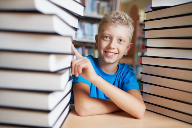 Little boy pointing a book Photo | Free Download