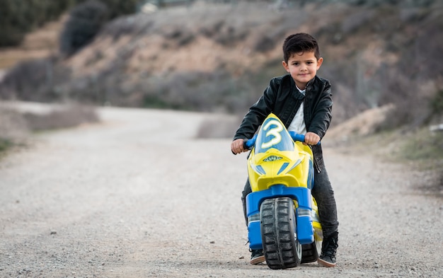 little boy riding motorcycle