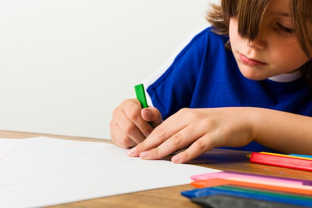 Premium Photo | Little caucasian boy drawing