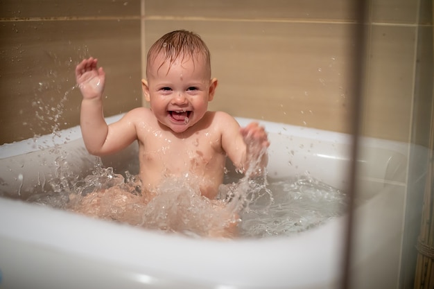 Premium Photo Little Charming Girl Babe Plays In The Water In A Small Inflatable Baby Pool Located In The Shower Stall In The Bathroom Baby Girl Smiling And Having Fun