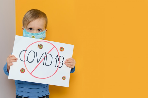 Little child in protective medical mask during coronavirus ...