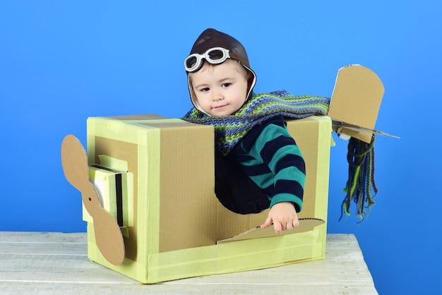 Premium Photo | Little cute boy cute boy playing with a cardboard ...