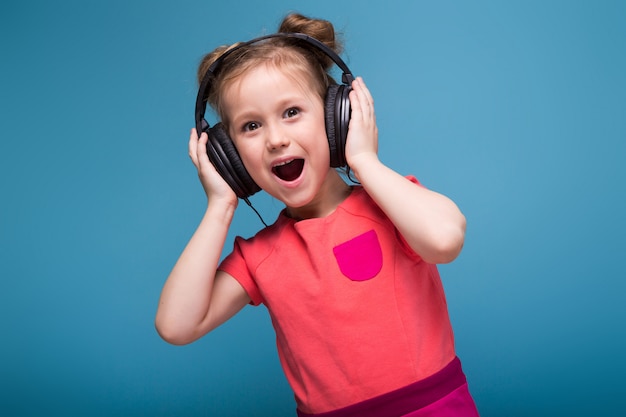 Premium Photo | Little cute girl in pink dress and headphones