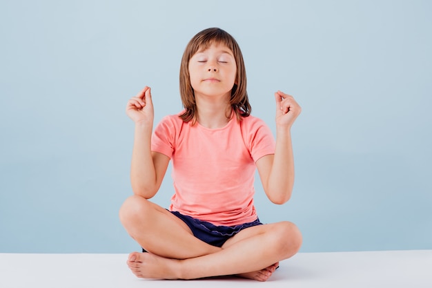 Premium Photo | Little cute girl in a yoga position