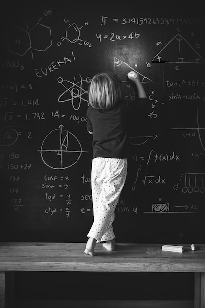 Premium Photo | Little genius drawing up some science