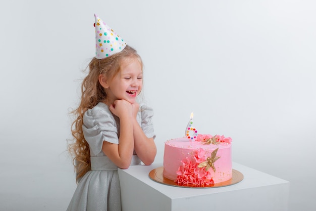 Premium Photo | Little girl celebrates her birthday blowing out the ...