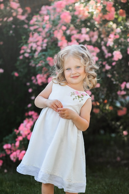 Premium Photo | Little girl in the flower garden