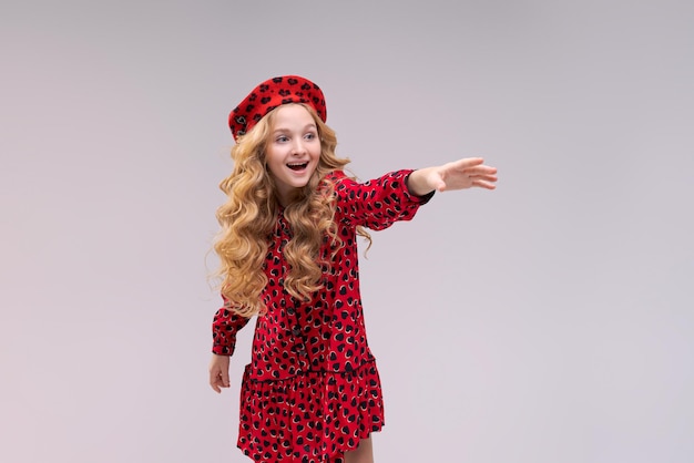 premium-photo-little-girl-in-french-style-hat-points-her-finger-to