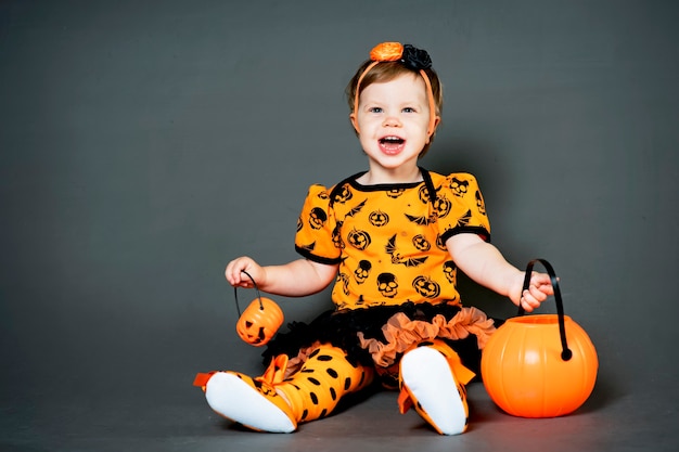 Premium Photo | Little girl in halloween costume with pumpkin jack ...