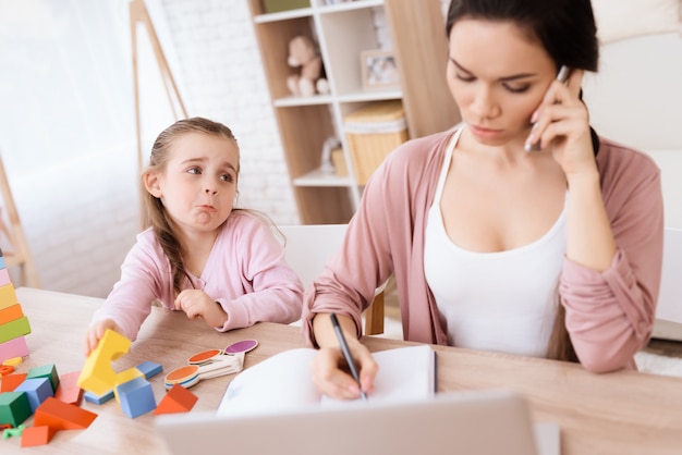 Premium Photo | The little girl misses her mother while talking on the ...