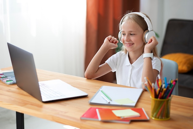 Little girl participating in online classes Free Photo
